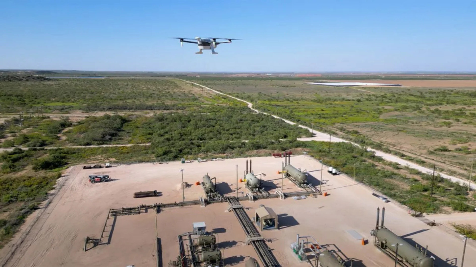 Drone flying over oilfield site conducting methane survey