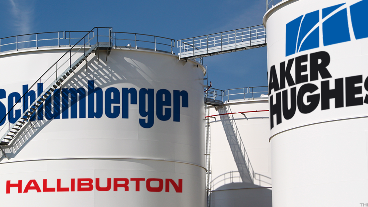Large oilfield storage tanks displaying SLB, Halliburton and Baker Hughes logos under clear sky