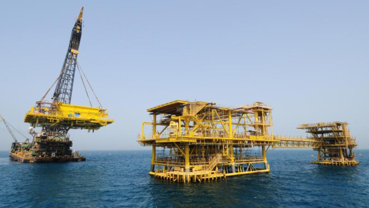 Offshore oil platform with heavy-lift vessel installing new yellow topside structure