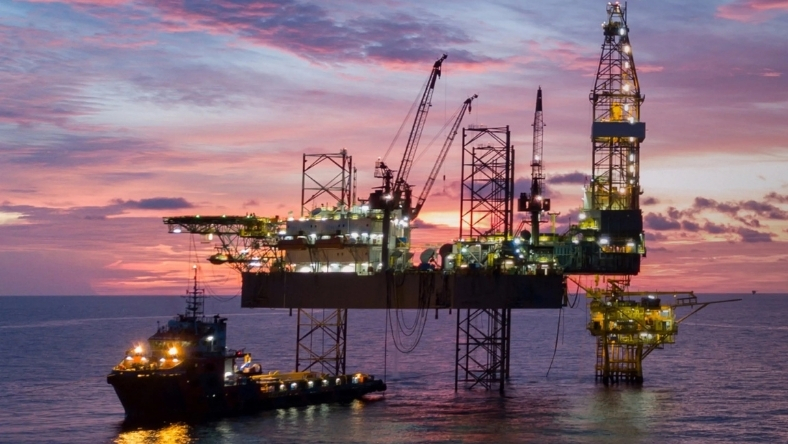 Offshore oil platform illuminated during active drilling operations