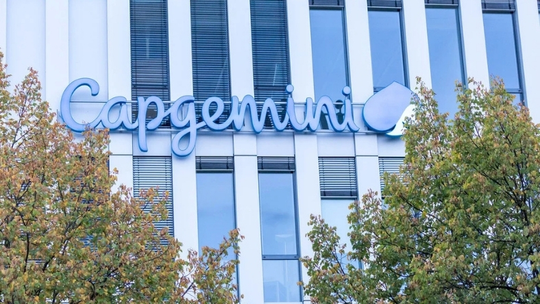 Capgemini logo displayed on office building exterior with trees in foreground